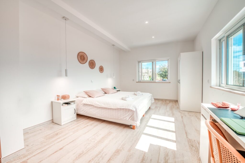 View of Lisbon bedroom showing furniture and two windows