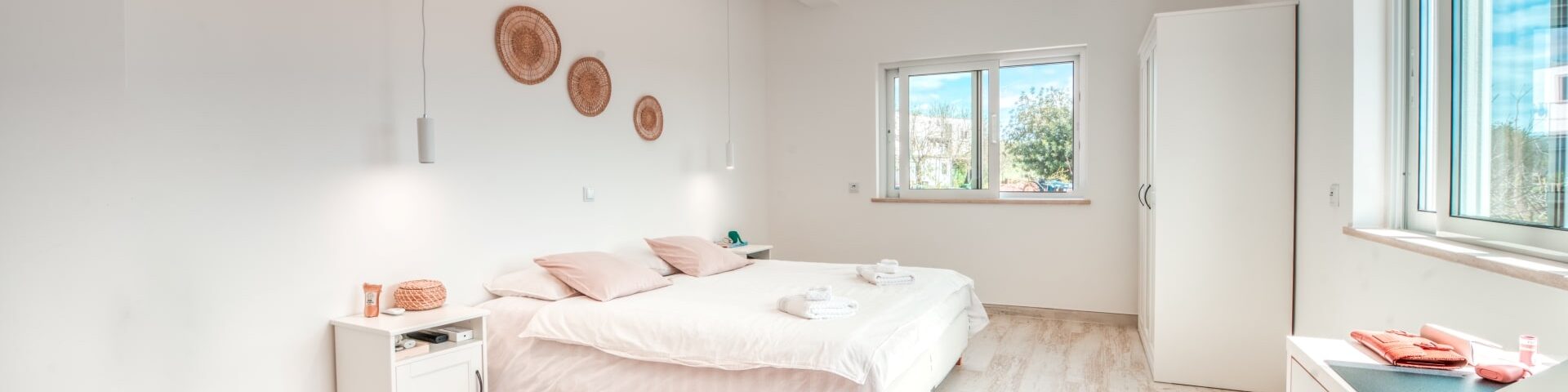 View of Lisbon bedroom showing furniture and two windows