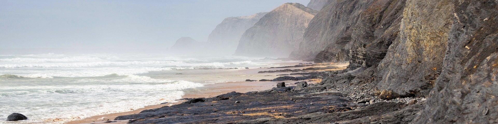 surf and relaxation at Praia da Cordoama near POMAR Coliving, Algarve panoramic view of Praia da Cordoama with cliffs and waves near POMAR Coliving, Algarve, Portugal