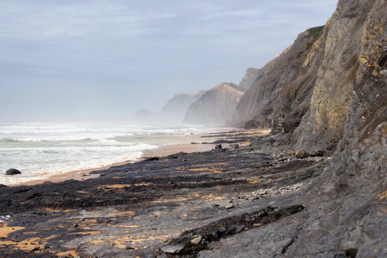 panoramic view of Praia da Cordoama with cliffs and waves near POMAR Coliving, Algarve, Portugal