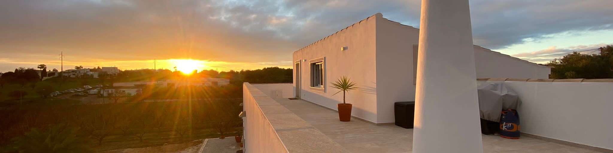 View of POMAR coliving rooftop during sunset