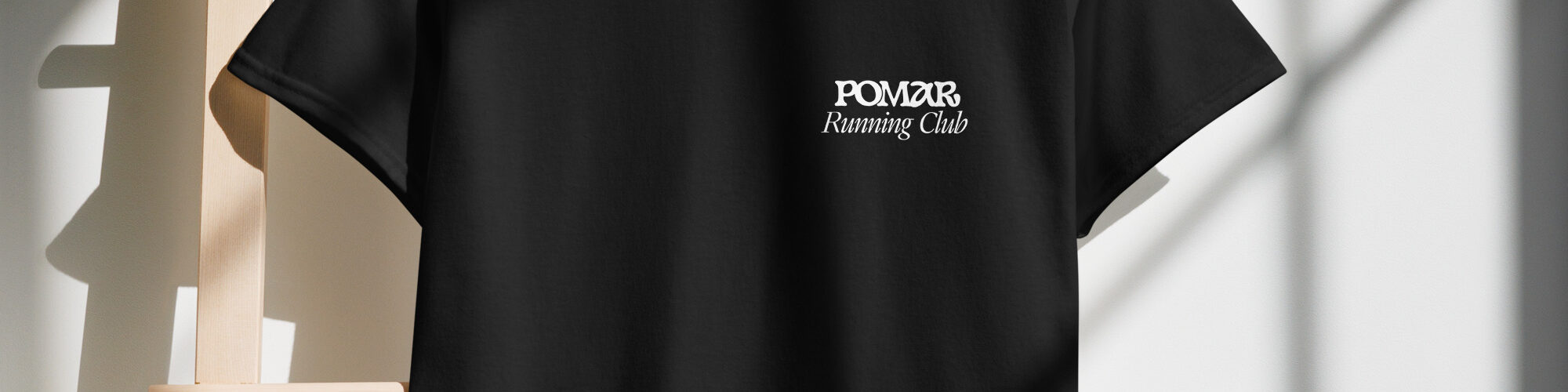 close-up view of the POMAR Running Club T-shirt, highlighting the community spirit of coliving in Algarve, Portugal