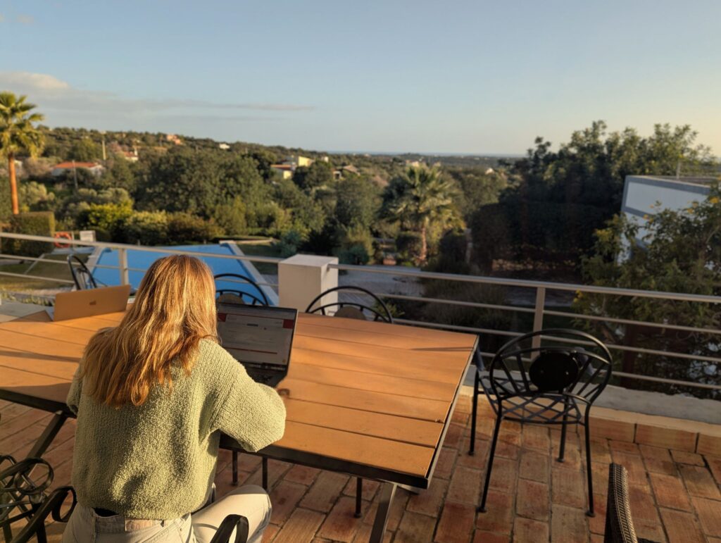 Young entrepreneur working from the terrace of POMAR na serra. Coliving in Algarve, Portugal.