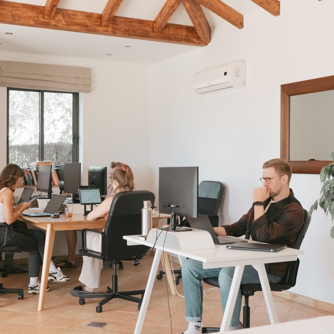 Colivers working on computers at coworking desks in POMAR na serra, Algarve, Portugal