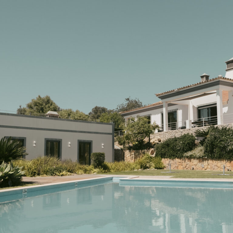 View of the pool and garden at POMAR Coliving, a boutique coliving house in the Algarve hills