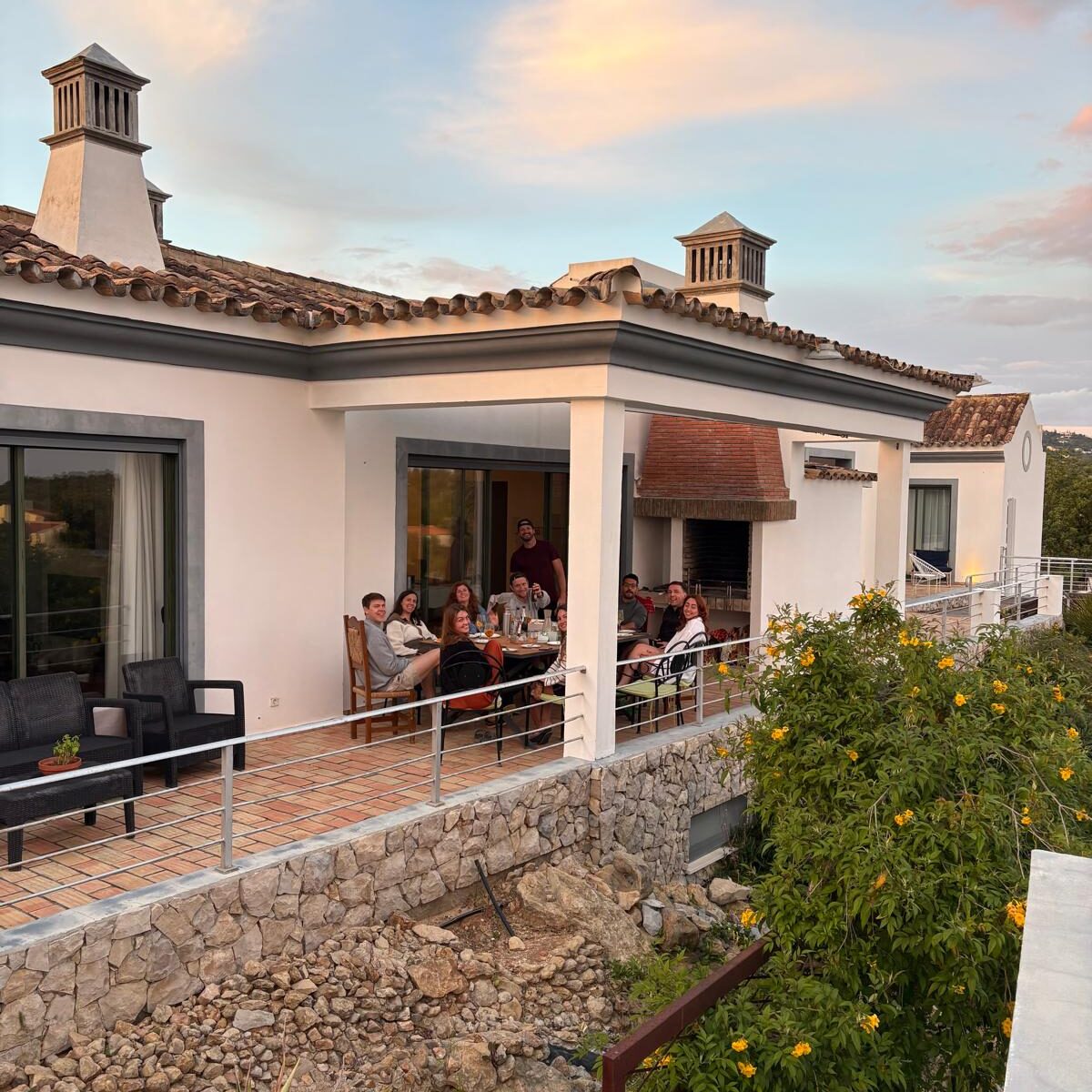 Colivers gathered for a shared dinner on the terrace at POMAR Coliving in the Algarve