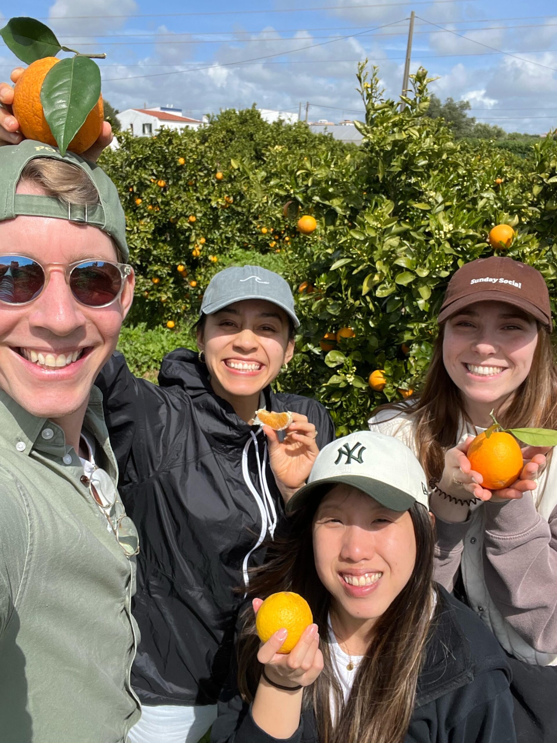 Colivers smiling in orange grove during harvest