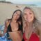 Rachel – Testimonials – POMAR coliving Two colivers smiling at the camera on sandy Faro Beach