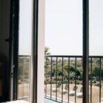 View from a bedroom at POMAR na praia overlooking pool loungers, trees, and the Algarve landscape