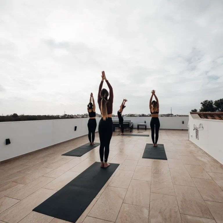 Group yoga session on a rooftop terrace